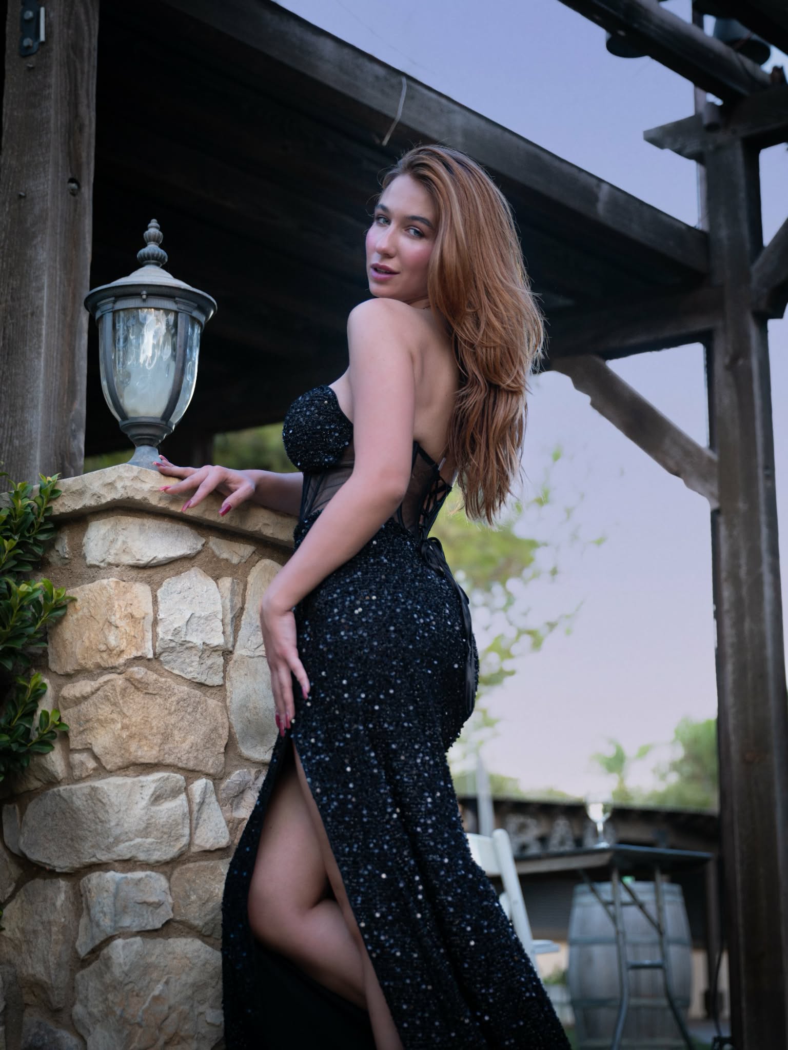 Iryna Vyacheslavivna posing in a black sequin gown on a stone terrace